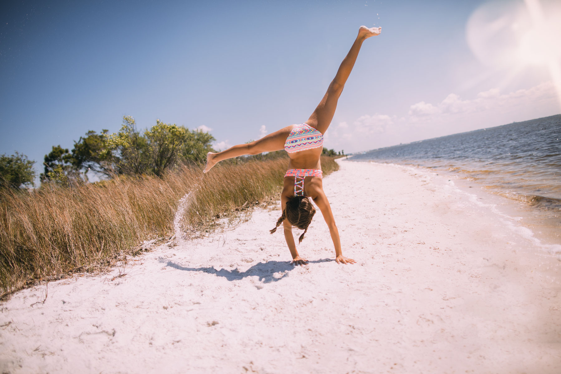 Girl Doing Cartwheel on Beach