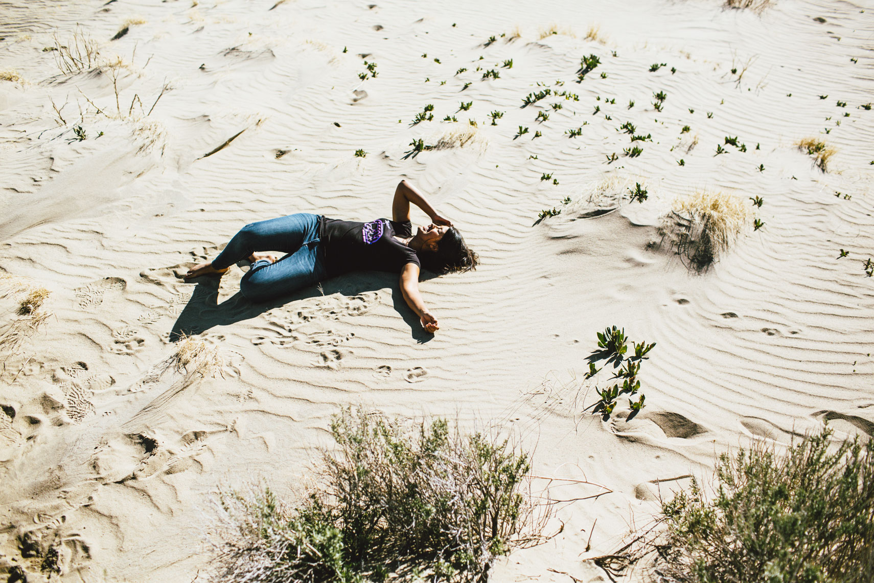 Girl lying in desert